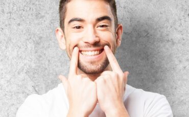 young man pointing his mouth